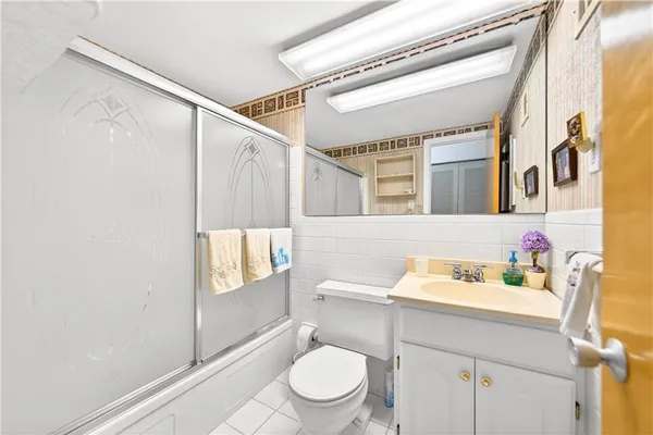 a bathroom with a sink a toilet and shower curtain