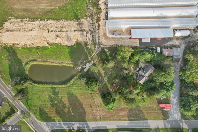 a view of a wooden house with large trees