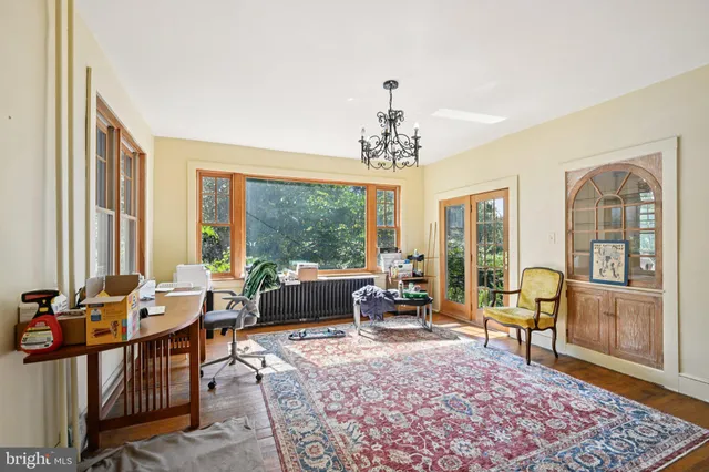 a view of a room with workspace and a window