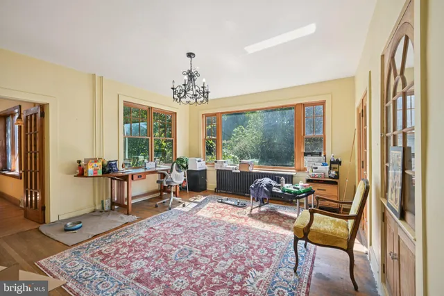a view of hallway with windows and chandelier