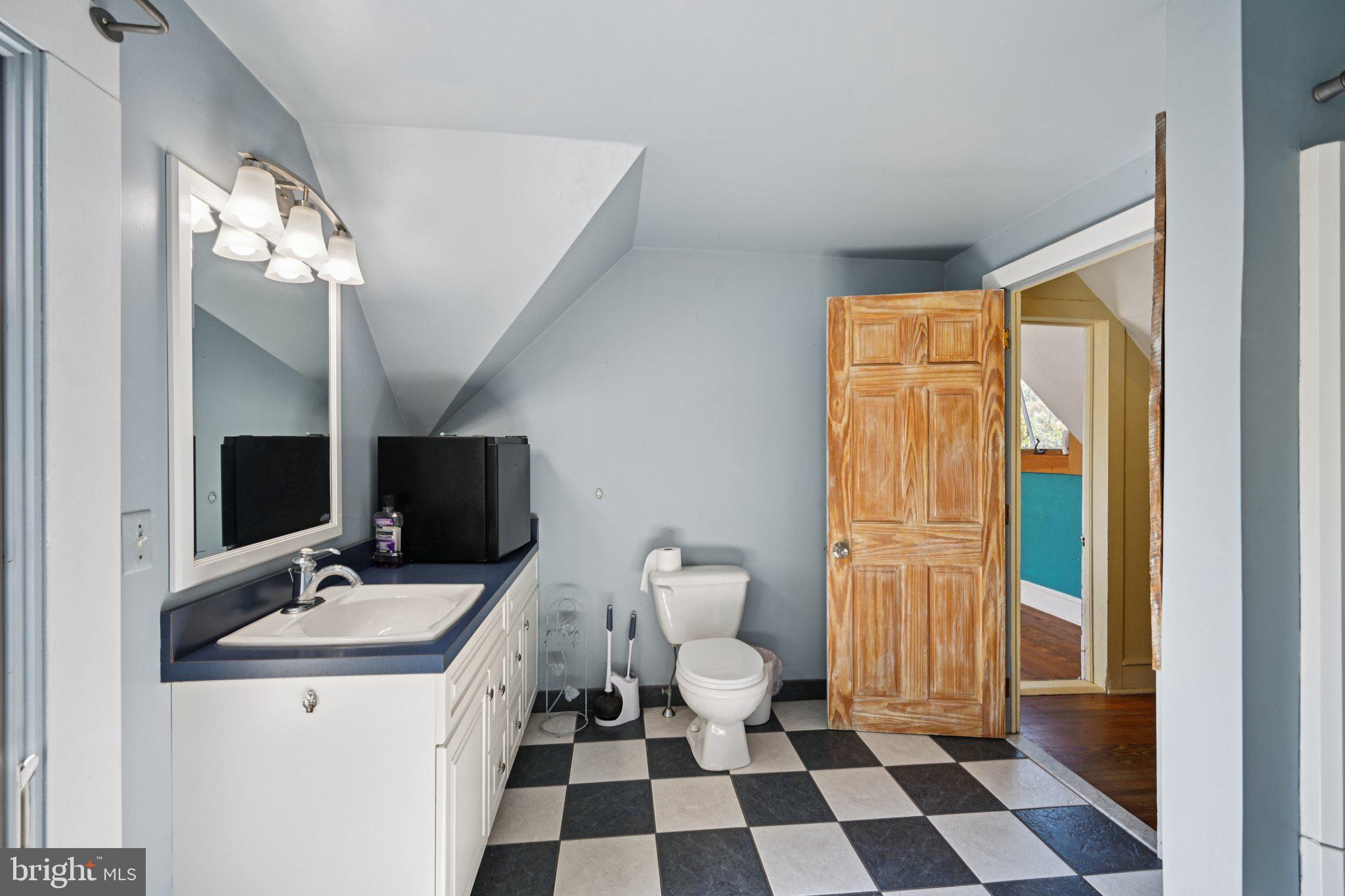 1001 South West Avenue Vineland, NJ 08360 - Photo 50 of 61 a bathroom with a sink a toilet a mirror and shower
