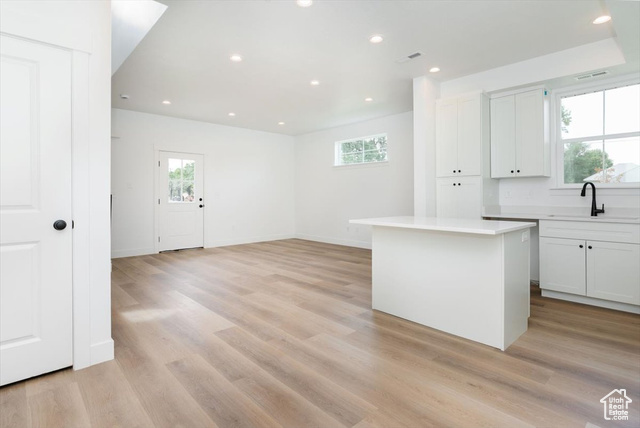 195 West 300 North Logan, UT 84321 - Photo 6 of 20 Kitchen with white cabinets, plenty of natural light, recessed lighting, and a kitchen island