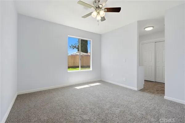 a bedroom with a bed and potted plant