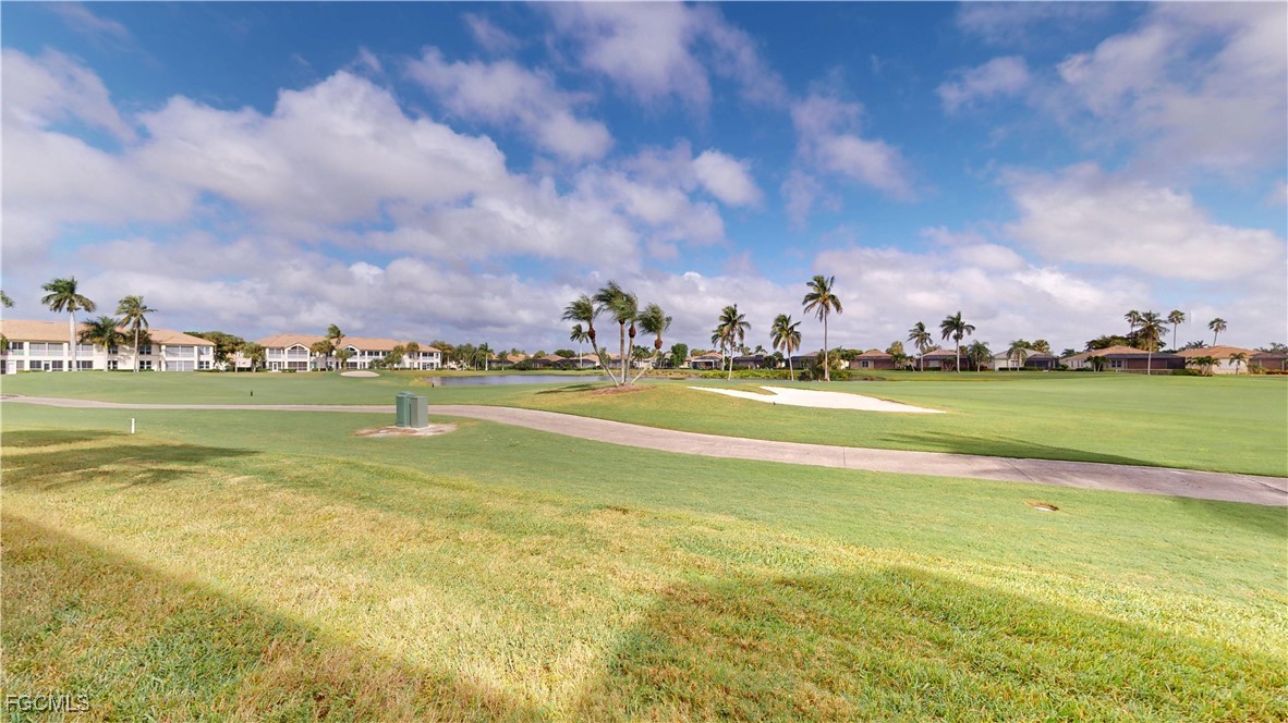 9130 Bayberry Bend, Unit 102 Fort Myers, FL 33908 - Photo 19 of 44 a view of building with ocean view and trees in the background
