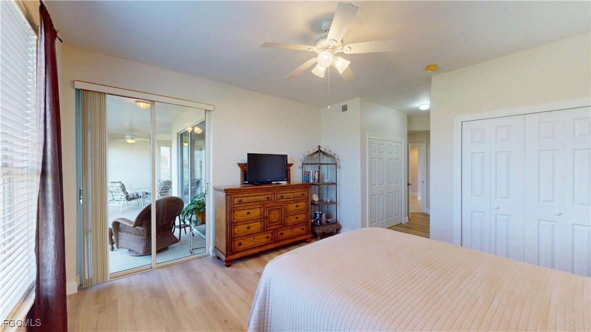 9130 Bayberry Bend, Unit 102 Fort Myers, FL 33908 - Photo 22 of 44 a bedroom with furniture and a chandelier