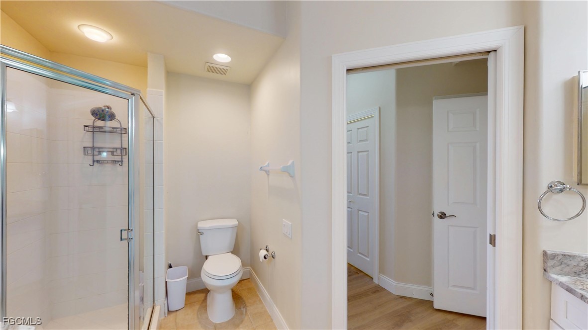 9130 Bayberry Bend, Unit 102 Fort Myers, FL 33908 - Photo 26 of 44 a bathroom with a granite countertop toilet and shower