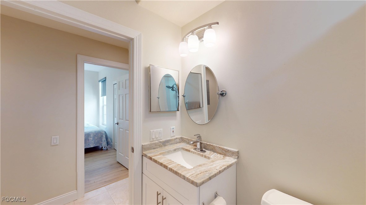 9130 Bayberry Bend, Unit 102 Fort Myers, FL 33908 - Photo 30 of 44 a bathroom with a sink and a mirror