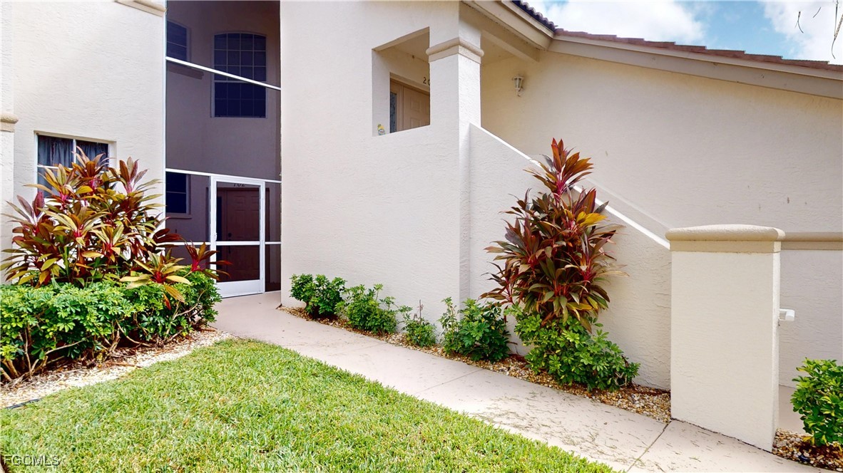 9130 Bayberry Bend, Unit 102 Fort Myers, FL 33908 - Photo 34 of 44 a flower plants in front of a glass door