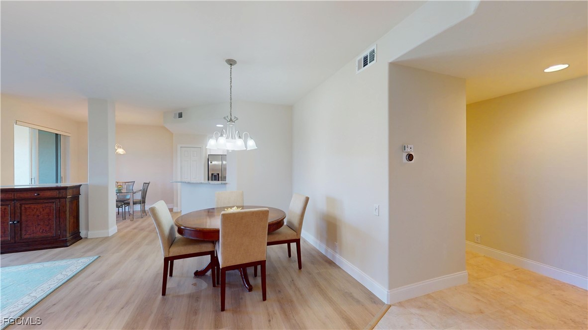 9130 Bayberry Bend, Unit 102 Fort Myers, FL 33908 - Photo 5 of 44 a view of a dining room with furniture and wooden floor