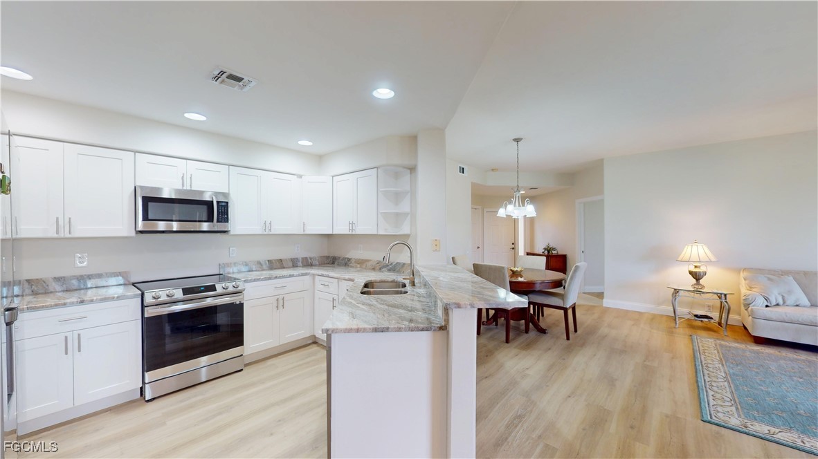 9130 Bayberry Bend, Unit 102 Fort Myers, FL 33908 - Photo 7 of 44 a living room with furniture and a wooden floor
