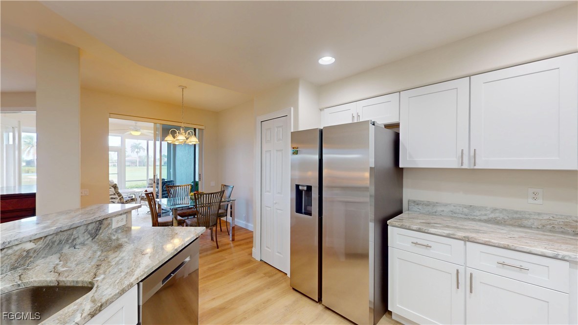 9130 Bayberry Bend, Unit 102 Fort Myers, FL 33908 - Photo 9 of 44 a kitchen with stainless steel appliances granite countertop a refrigerator and a sink