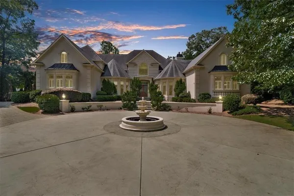 a front view of a house with a yard and a garage