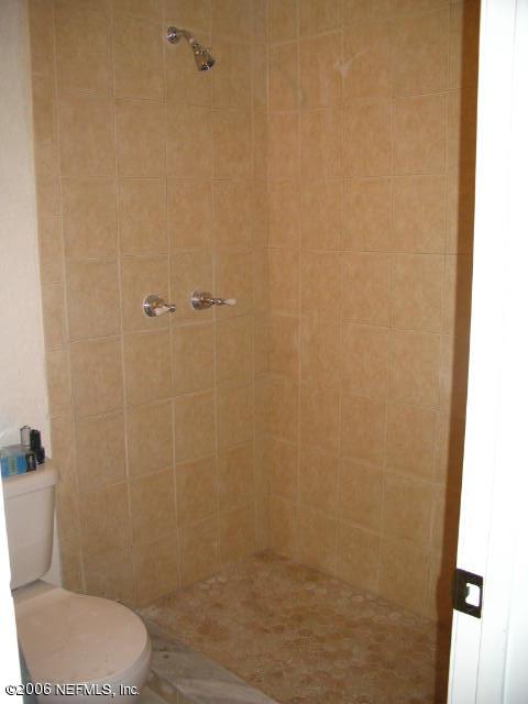 6142 Spring Hammock Road Jacksonville, FL 32226 - Photo 6 of 8 a bathroom with a toilet and a shower