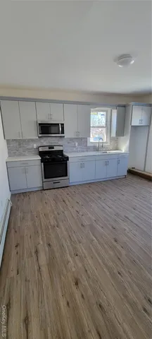 a kitchen with wooden floors and a sink