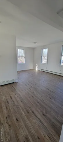 a view of a kitchen with wooden floor and a sink