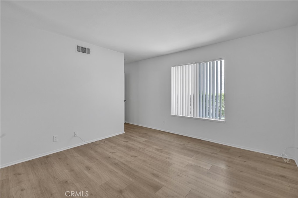 45 Orchard Irvine, CA 92618 - Photo 11 of 29 an empty room with wooden floor and windows