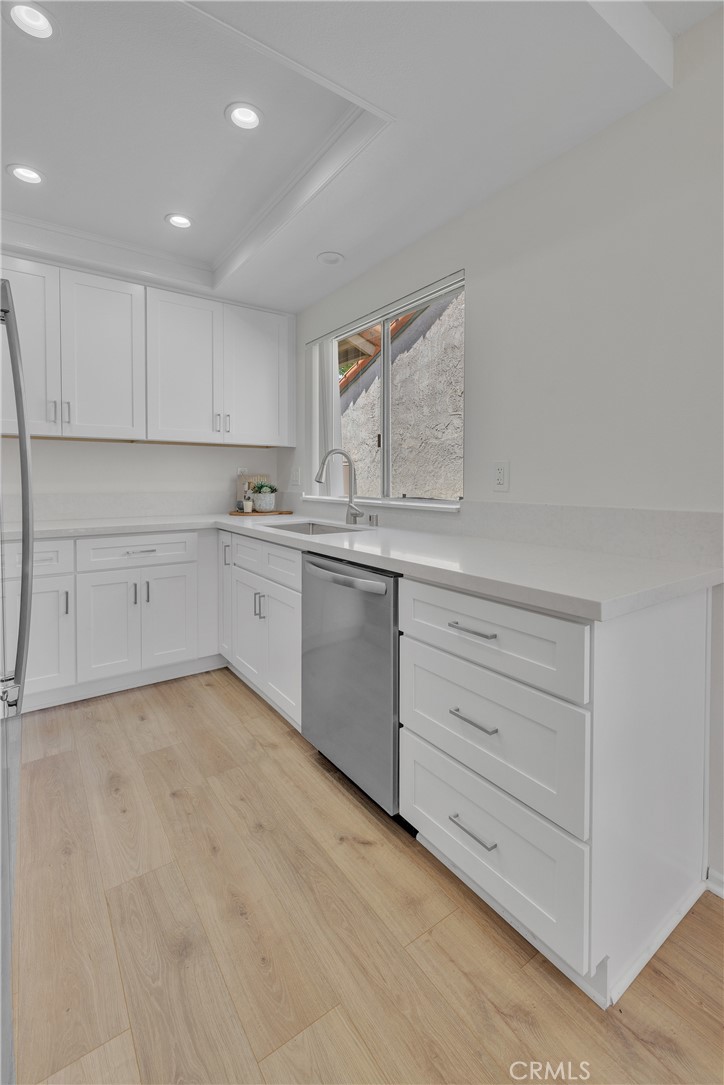 45 Orchard Irvine, CA 92618 - Photo 14 of 29 a kitchen with granite countertop white cabinets and white stainless steel appliances