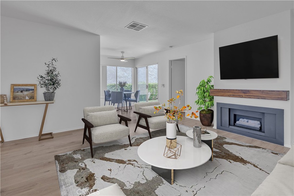 45 Orchard Irvine, CA 92618 - Photo 2 of 29 a living room with furniture a flat screen tv and a fireplace