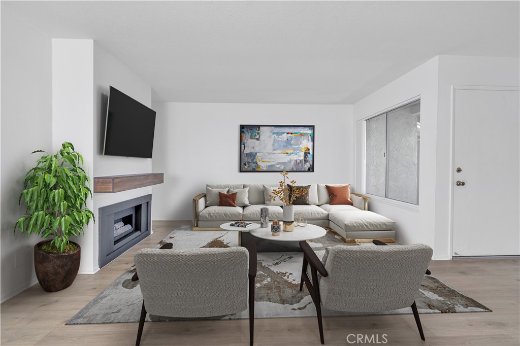 45 Orchard Irvine, CA 92618 - Photo 3 of 29 a living room with fireplace furniture and a potted plant