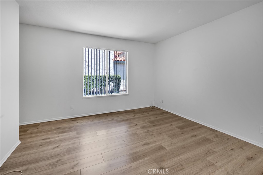 45 Orchard Irvine, CA 92618 - Photo 10 of 29 an empty room with wooden floor and windows