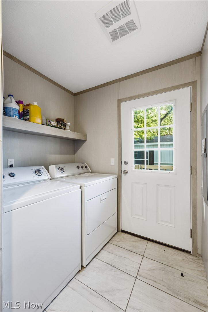 4516 Navarre Road Southwest, Unit 13 Canton, OH 44706 - Photo 11 of 30 Utility area featuring light-toned wall paneling, white door with window pane inserts, and light-toned floor tiling