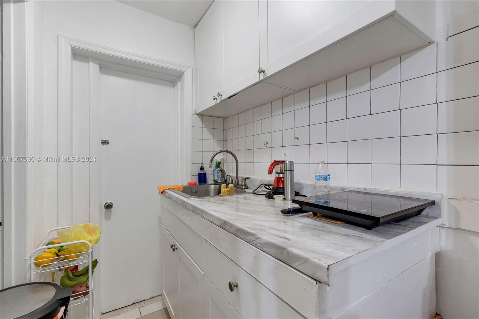 3015 Southwest 103rd Place Miami, FL 33165 - Photo 20 of 32 a kitchen with a sink and cabinets