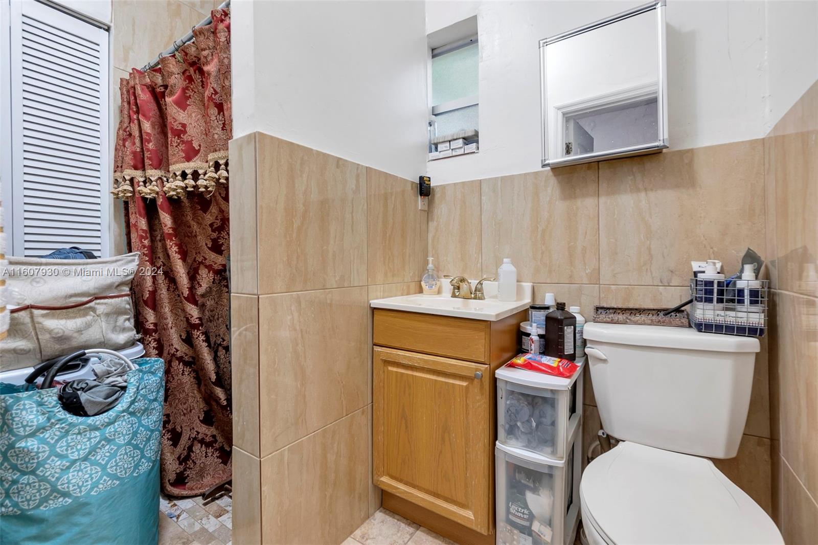 3015 Southwest 103rd Place Miami, FL 33165 - Photo 23 of 32 a bathroom with a toilet and a shower curtain