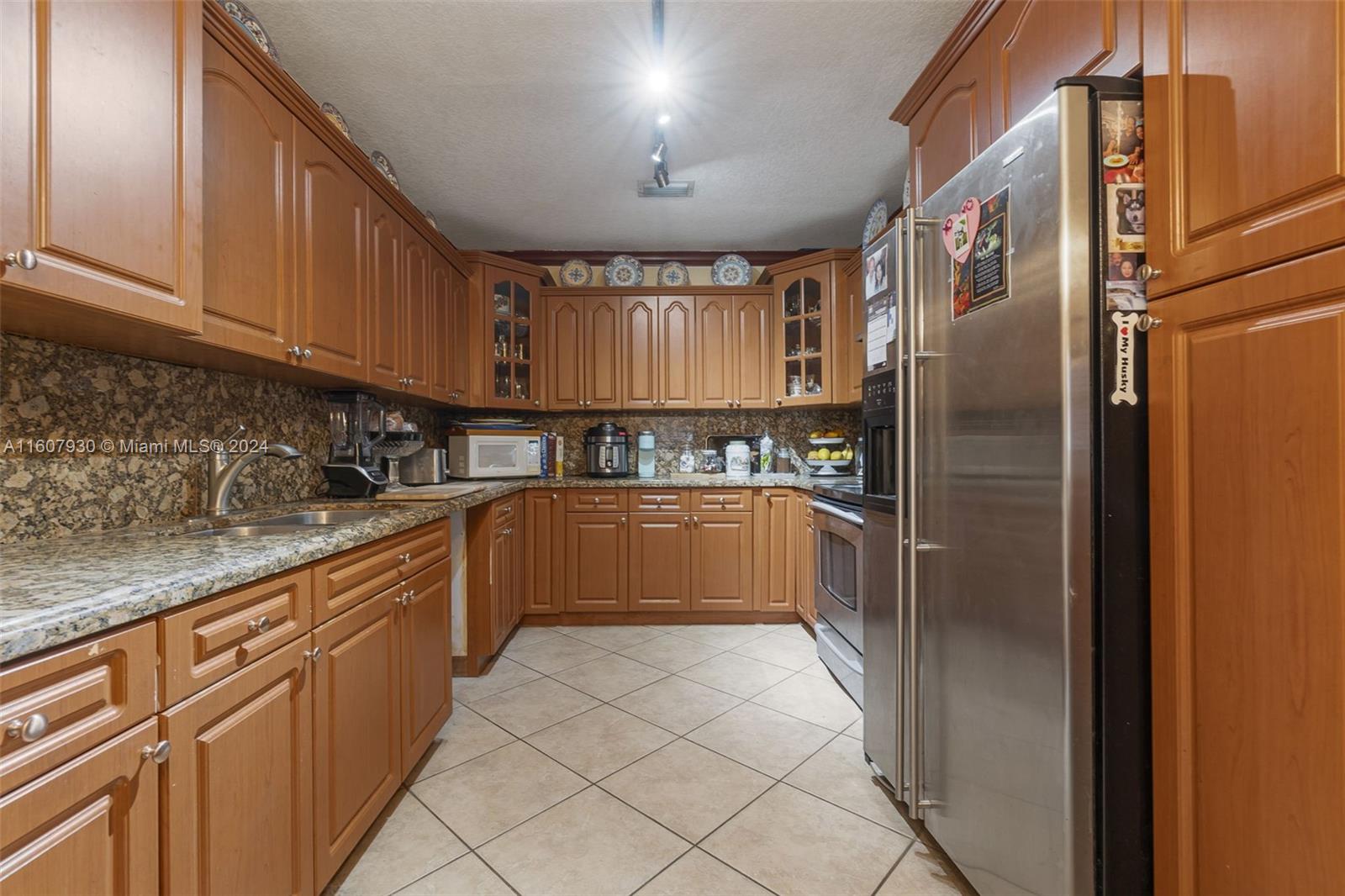 3015 Southwest 103rd Place Miami, FL 33165 - Photo 4 of 32 a kitchen with stainless steel appliances granite countertop a refrigerator