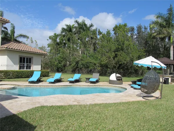 a swimming pool with outdoor seating yard