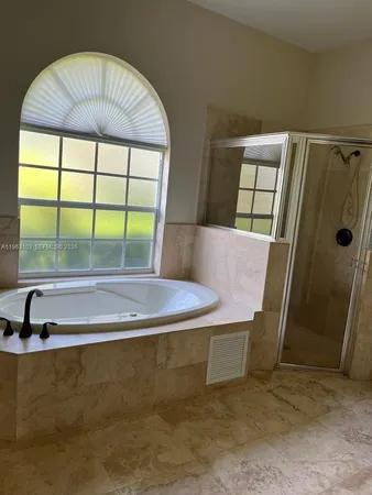 a spacious bathroom with a granite countertop sink and a mirror