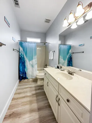 a bathroom with a sink vanity and a mirror