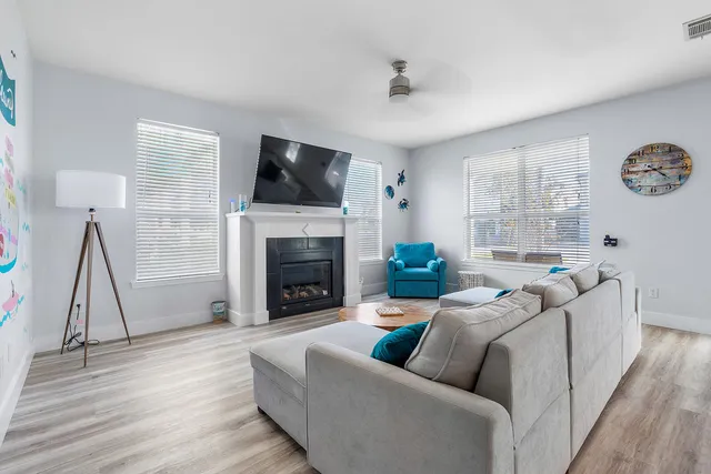 a living room with furniture a flat screen tv and a fireplace