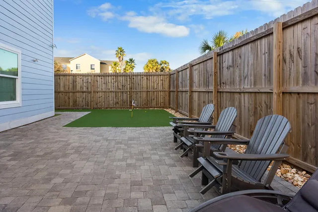 a view of a chairs and tables in the back yard of the house