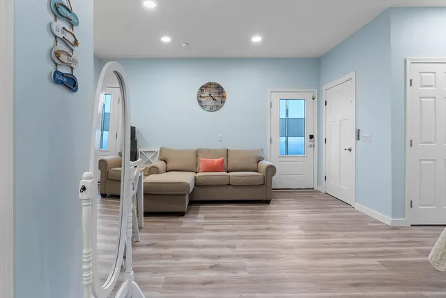 a living room with furniture and a wooden floor