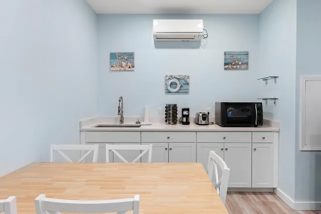 a spacious bedroom with a bed and a flat screen tv
