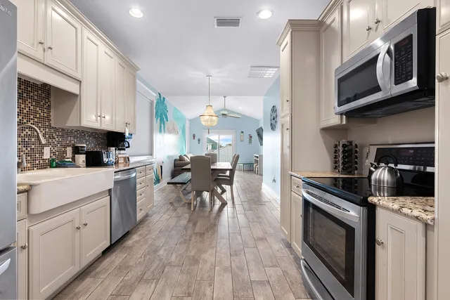 a kitchen with white cabinets and refrigerator