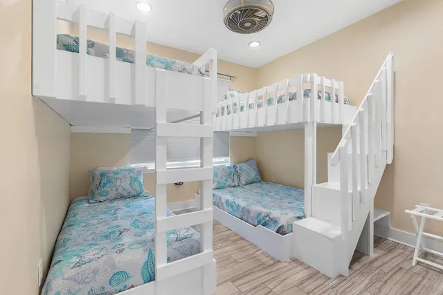 a living room with a table chairs and wooden floor