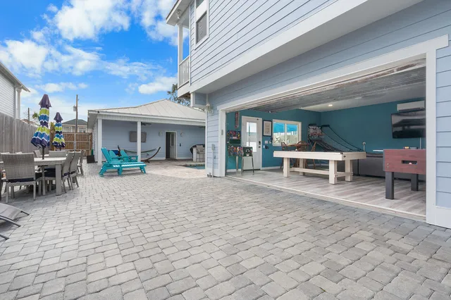 a view of a house with backyard porch and sitting area
