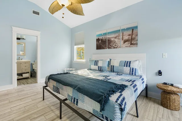 a bedroom with a bed and flat screen tv