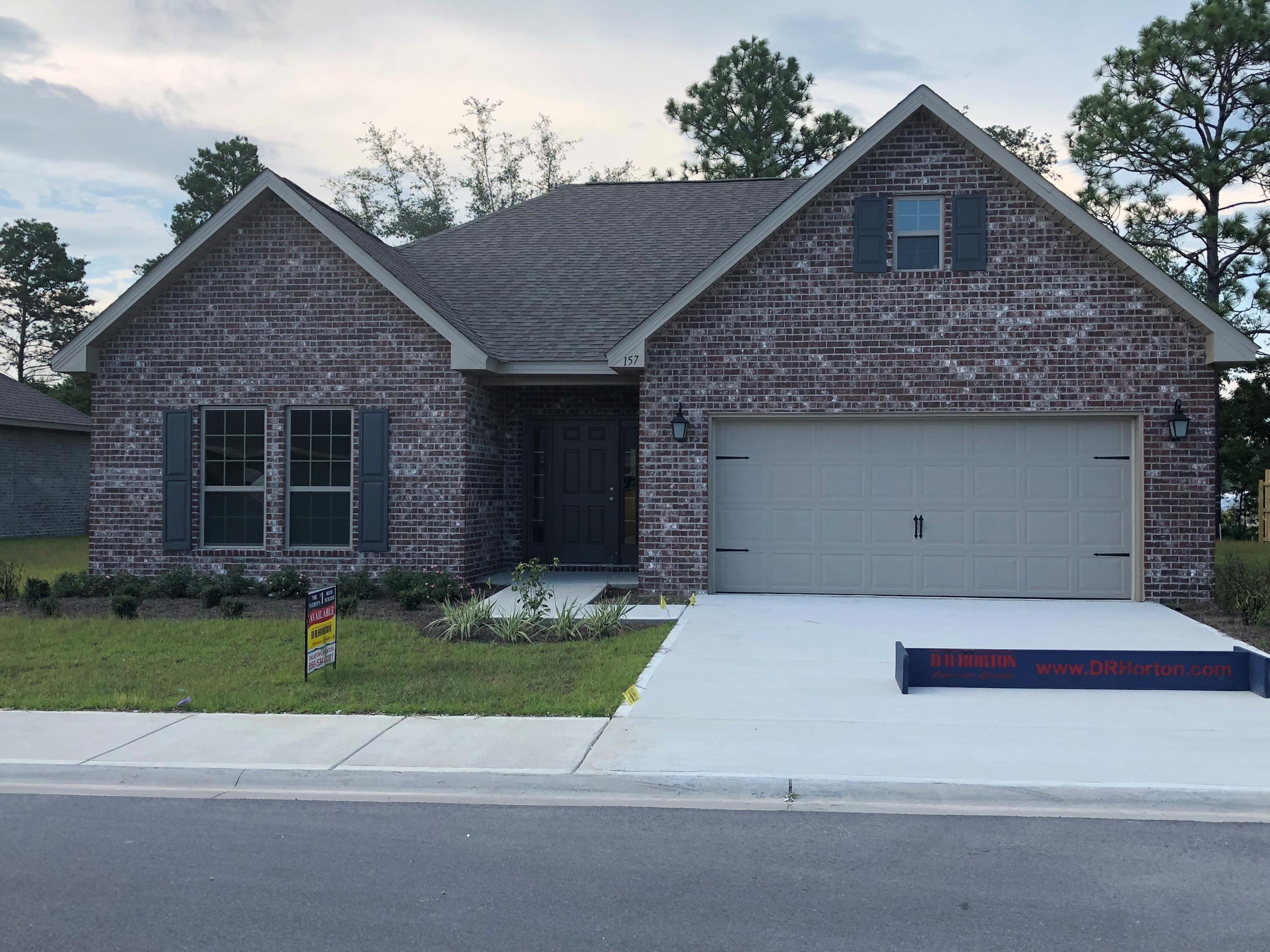 157 Wayne Trail Santa Rosa Beach, FL 32459 - Photo 2 of 17 a front view of a house with a yard and garage