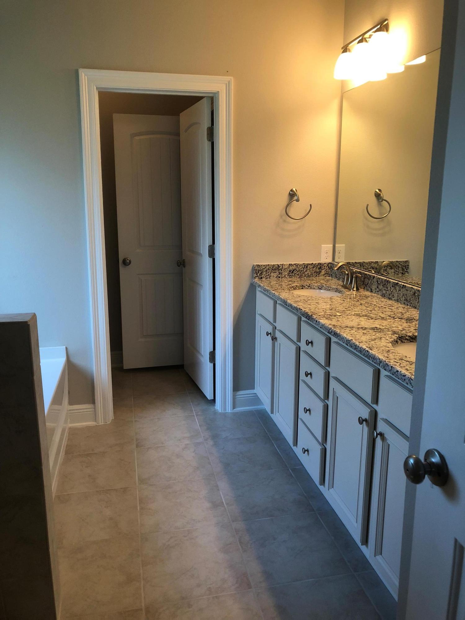 157 Wayne Trail Santa Rosa Beach, FL 32459 - Photo 12 of 17 a bathroom with a granite countertop sink and a mirror
