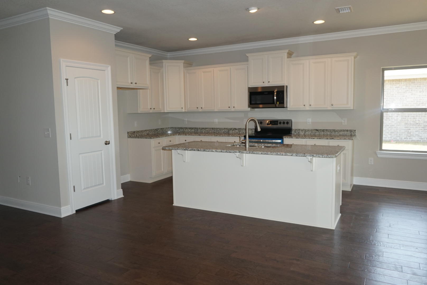 157 Wayne Trail Santa Rosa Beach, FL 32459 - Photo 3 of 17 a kitchen with stainless steel appliances granite countertop a stove a sink and a microwave