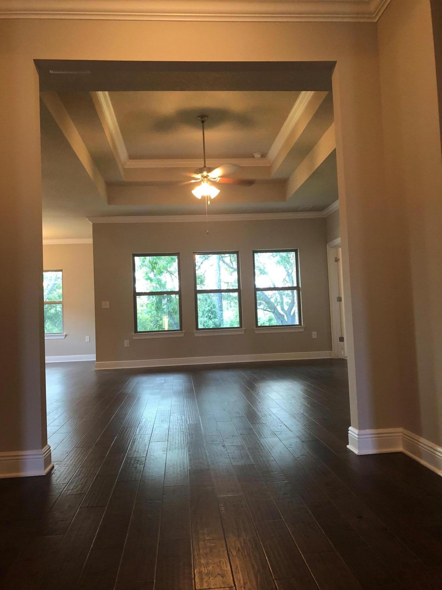 157 Wayne Trail Santa Rosa Beach, FL 32459 - Photo 9 of 17 an empty room with wooden floor and windows