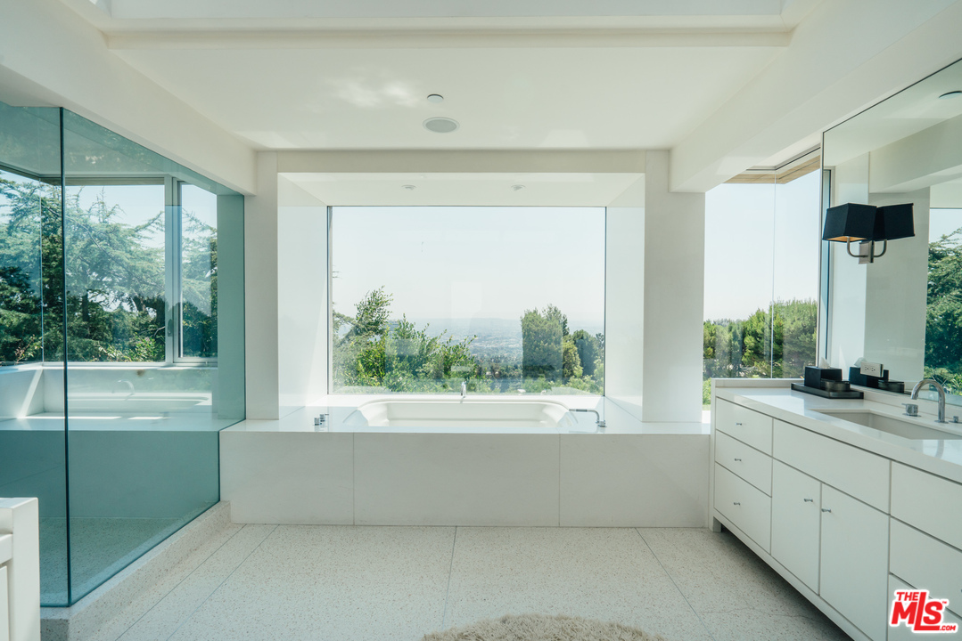 1470 Carla Ridge Beverly Hills, CA 90210 - Photo 17 of 44 a view of bathroom with a tub and window