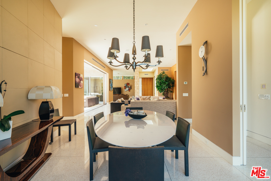 1470 Carla Ridge Beverly Hills, CA 90210 - Photo 23 of 44 a view of a dining room with furniture and a chandelier