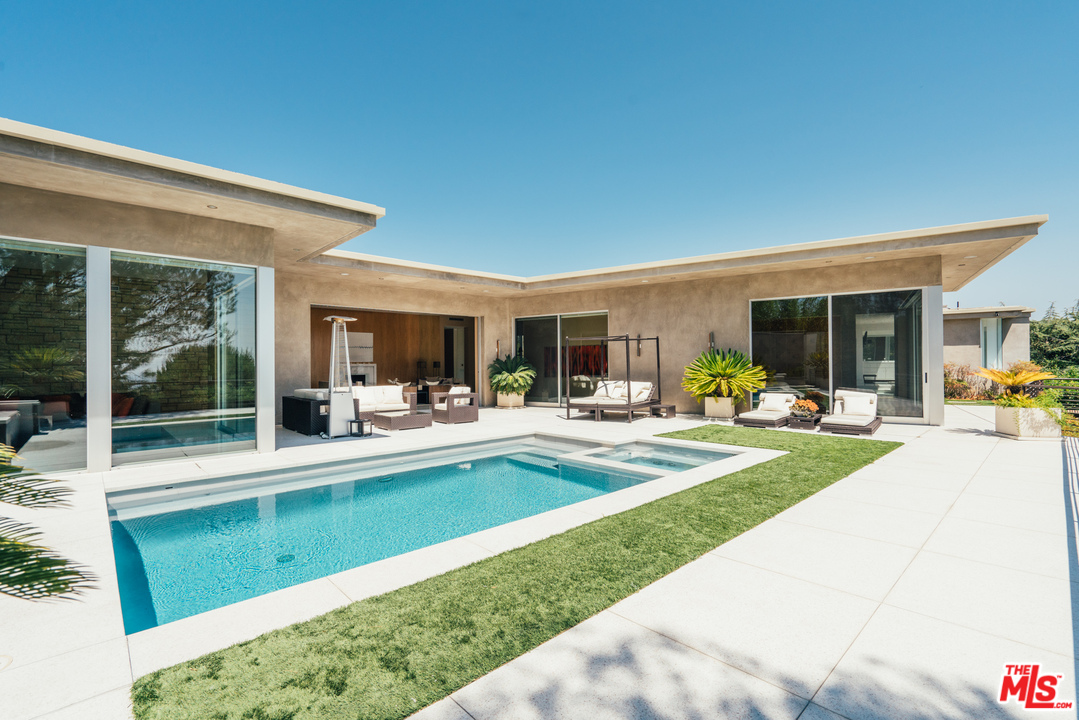 1470 Carla Ridge Beverly Hills, CA 90210 - Photo 35 of 44 a view of a patio with table and chairs and potted plants