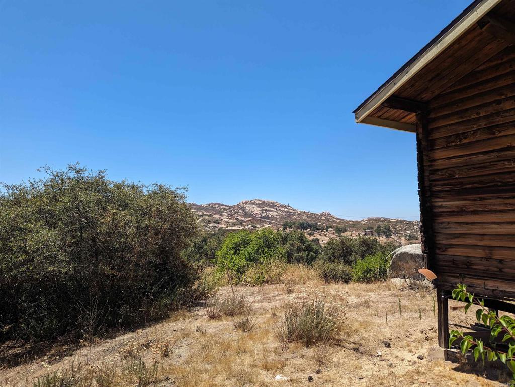 3910 Carveacre Road Alpine, CA 91901 - Photo 7 of 20 a view of a yard with mountain and wooden fence