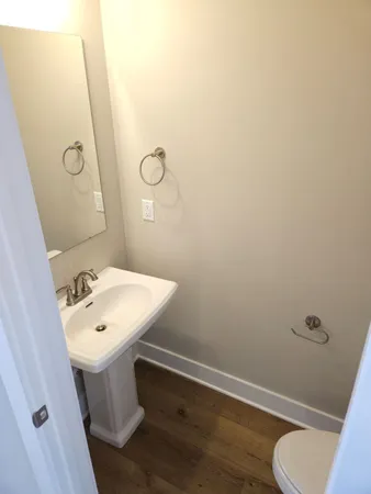 a bathroom with a sink mirror vanity and toilet