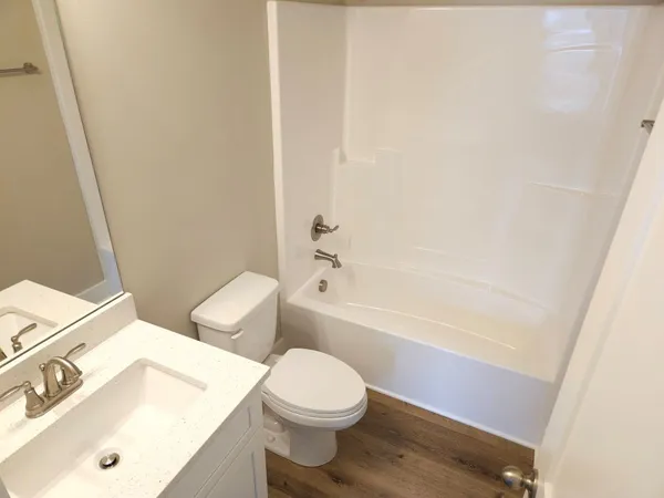 a bathroom with a sink a toilet and bathtub