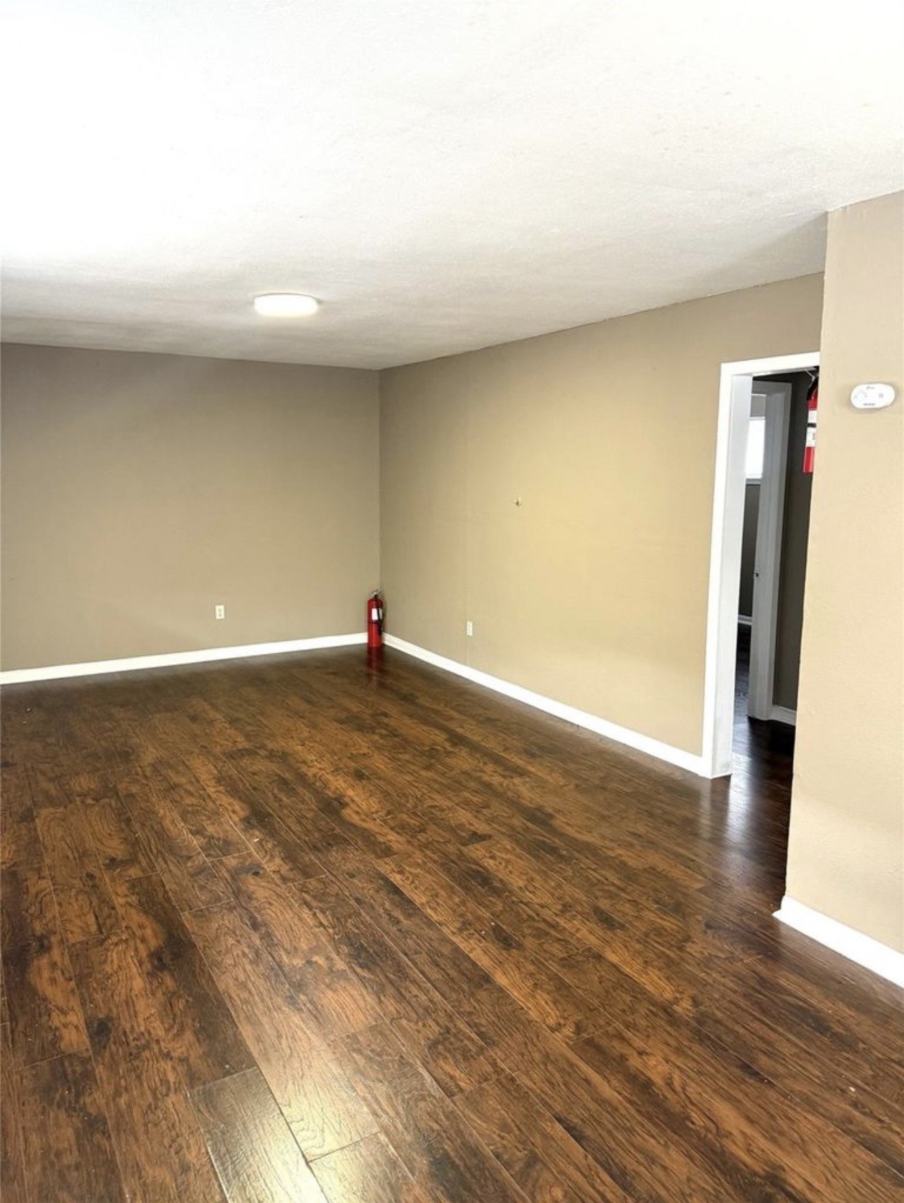 5412 Market Street, Unit 3 Houston, TX 77020 - Photo 3 of 11 a view of an empty room with wooden floor and a window